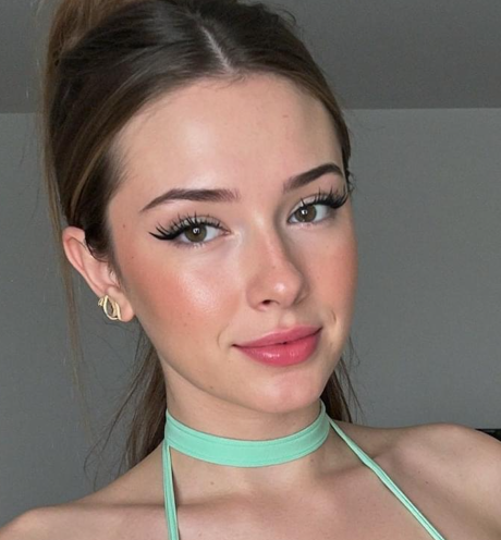 Sultry Brunette Teases in Tight Green Halter Dress